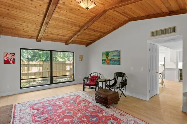 a view of a house with backyard sitting area and garden