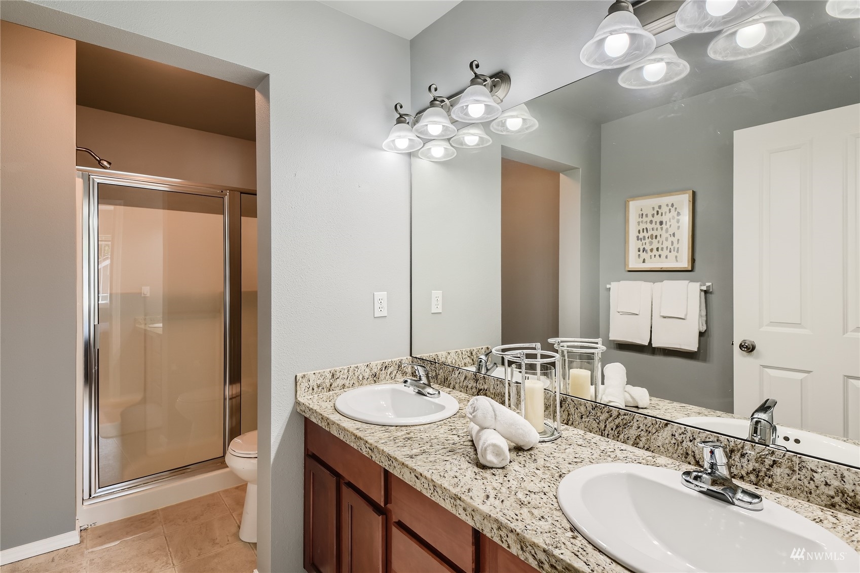 1054 215th Place Southeast Bothell, WA 98021 - Photo 15 of 28 a bathroom with a granite countertop sink a large mirror and a shower