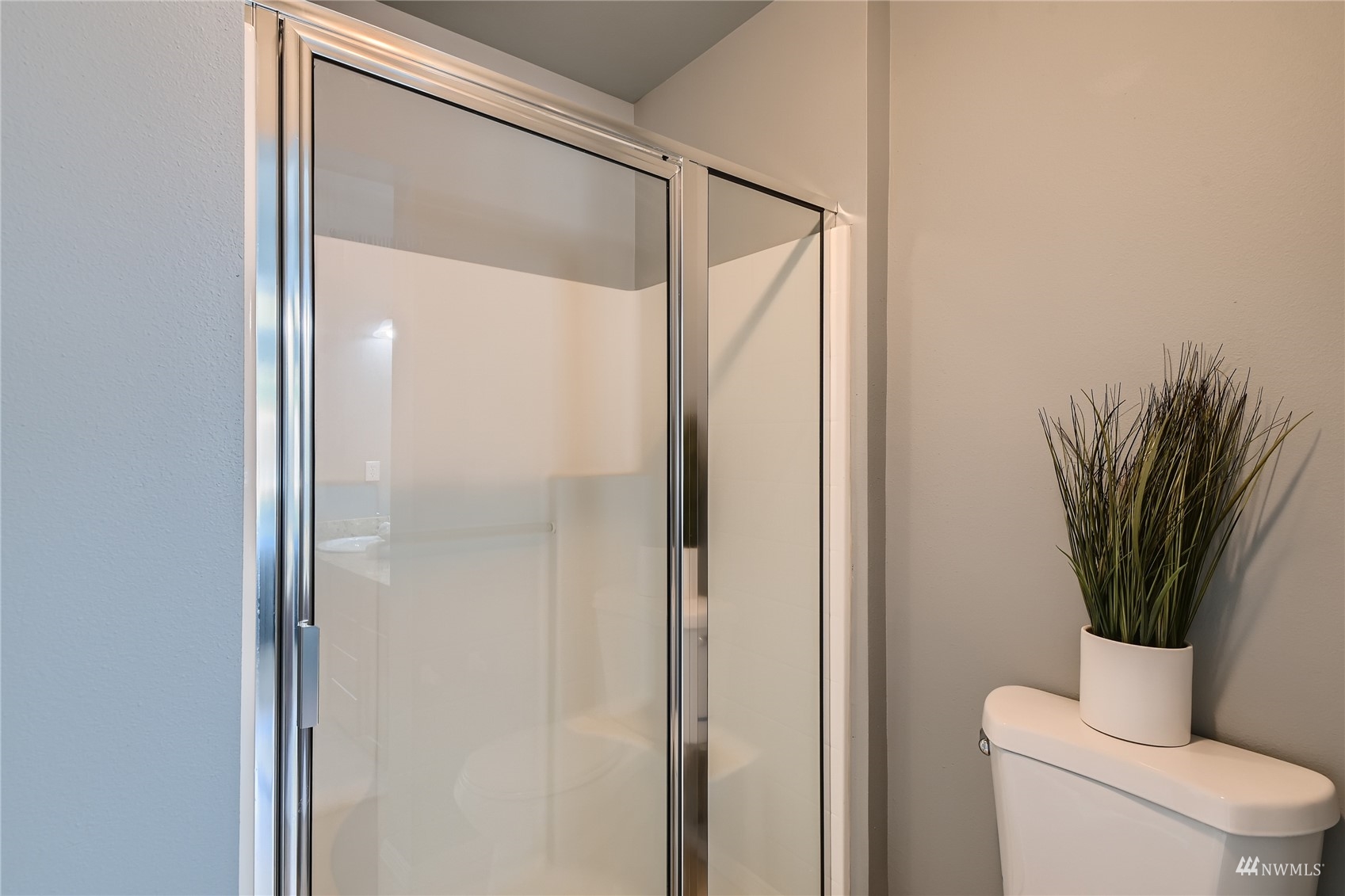 1054 215th Place Southeast Bothell, WA 98021 - Photo 16 of 28 a bathroom with a glass shower door