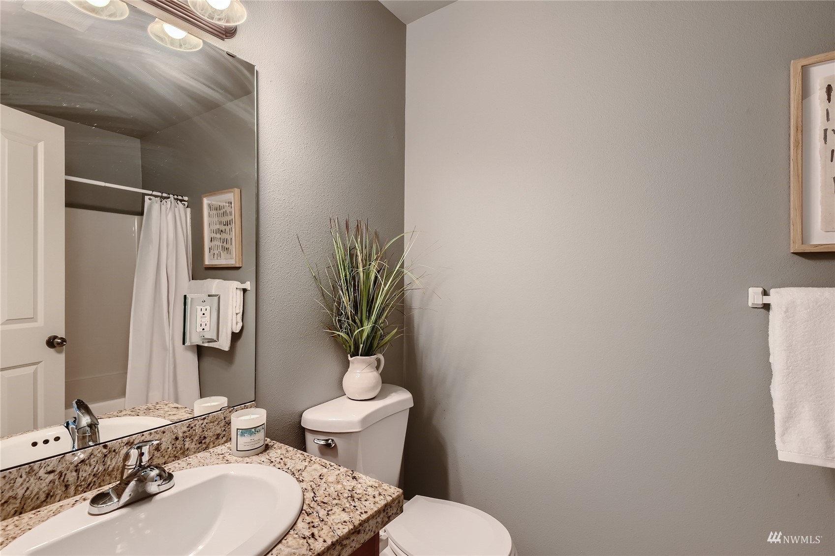 1054 215th Place Southeast Bothell, WA 98021 - Photo 18 of 28 a bathroom with a toilet a sink and mirror