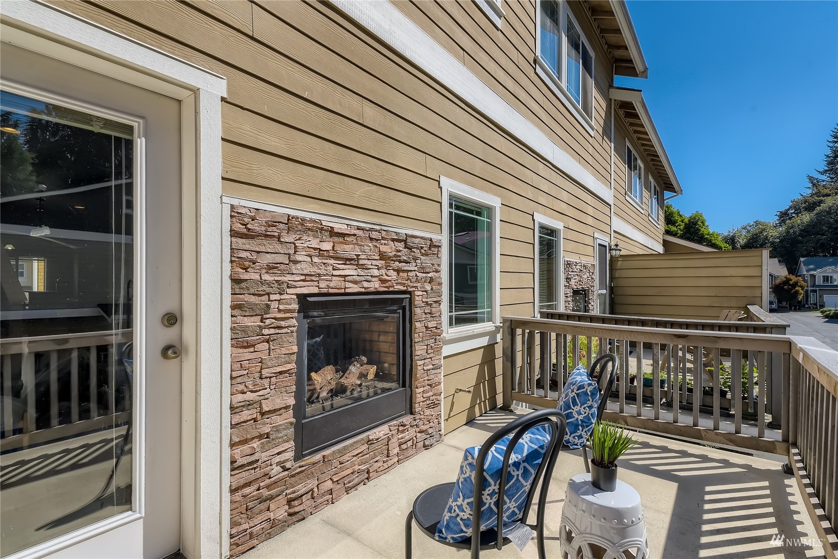 1054 215th Place Southeast Bothell, WA 98021 - Photo 25 of 28 a view of a balcony with two chairs and a fireplace