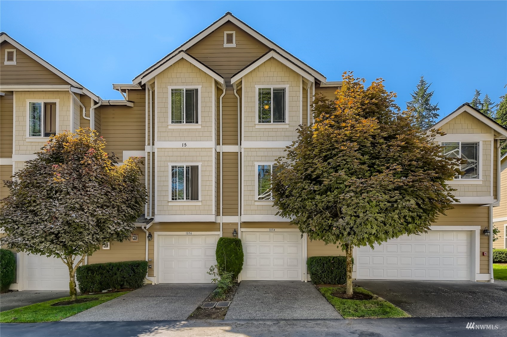 1054 215th Place Southeast Bothell, WA 98021 - Photo 26 of 28 a front view of a house with a yard and trees