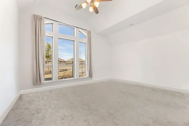 a bedroom with a large bed and a potted plant