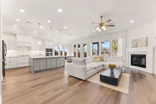 a living room with furniture fireplace and kitchen view
