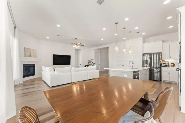 a kitchen with kitchen island granite countertop a sink appliances and cabinets