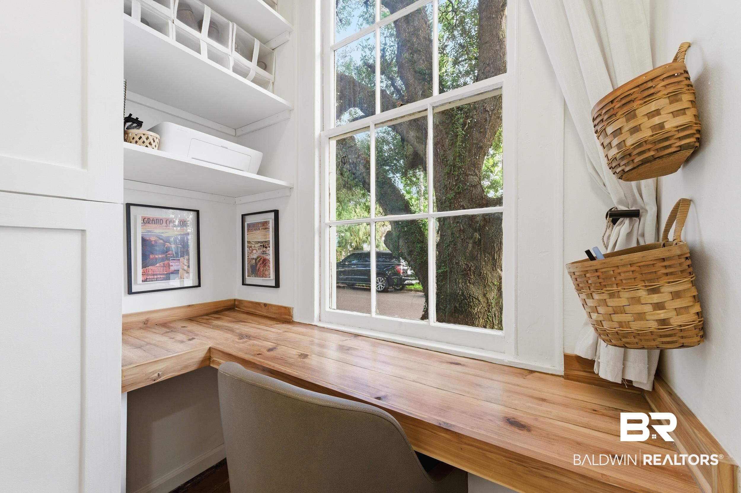 350 Charles Street Mobile, AL 36604 - Photo 23 of 52 Built-in corner desk with a natural wood finish, complemented by white shelving and a multi-pane window