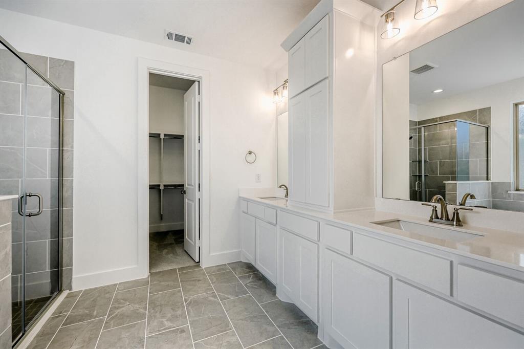 180 Buffalo Boulevard Rhome, TX 76078 - Photo 11 of 28 a bathroom with a double vanity sink mirror and shower