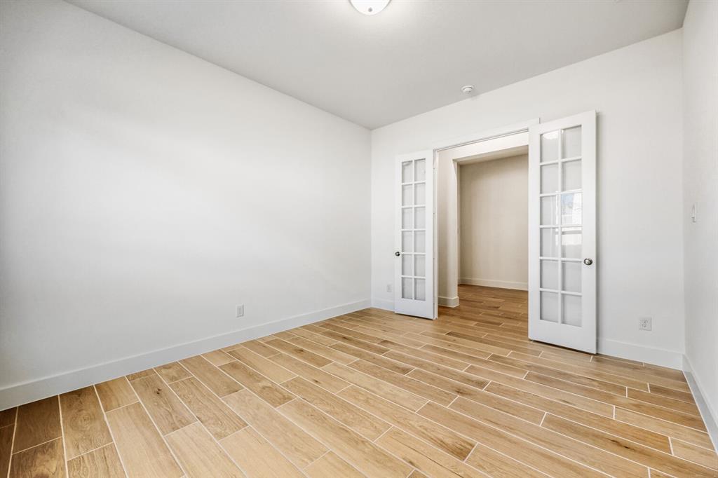 180 Buffalo Boulevard Rhome, TX 76078 - Photo 2 of 28 an empty room with wooden floor and closet