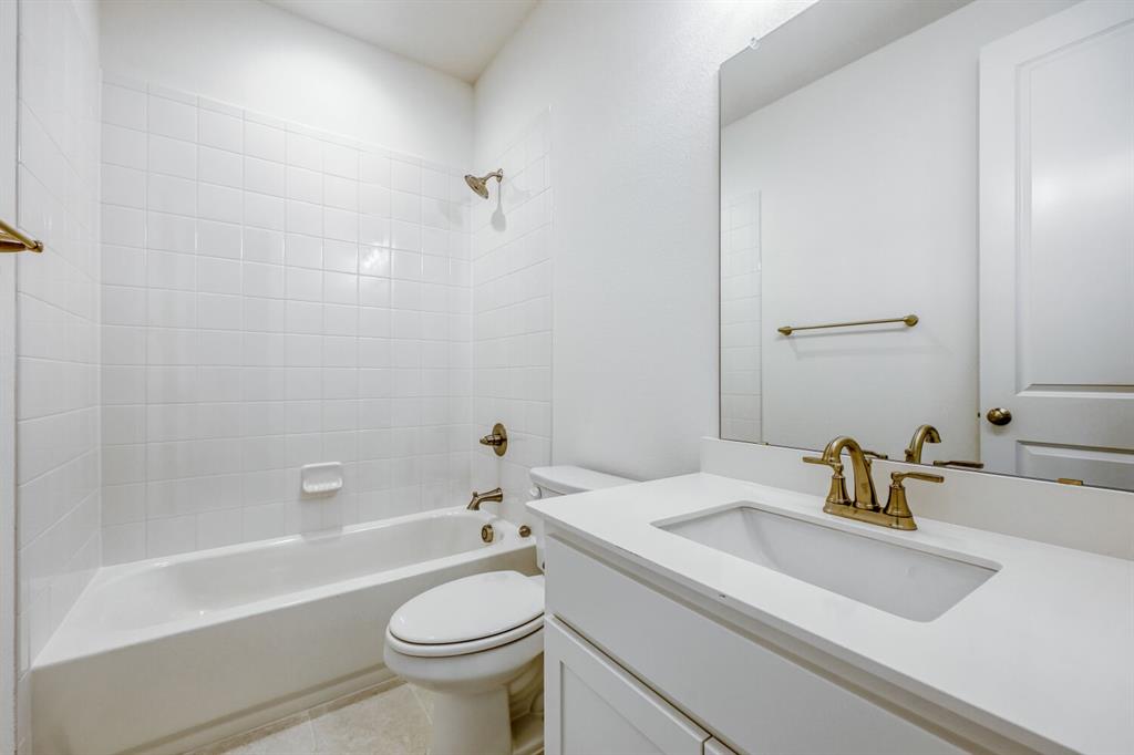 180 Buffalo Boulevard Rhome, TX 76078 - Photo 20 of 28 a bathroom with a sink a toilet and a bathtub