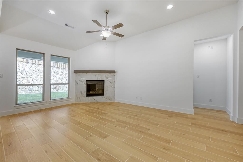 180 Buffalo Boulevard Rhome, TX 76078 - Photo 3 of 28 a view of an empty room with a window and fireplace