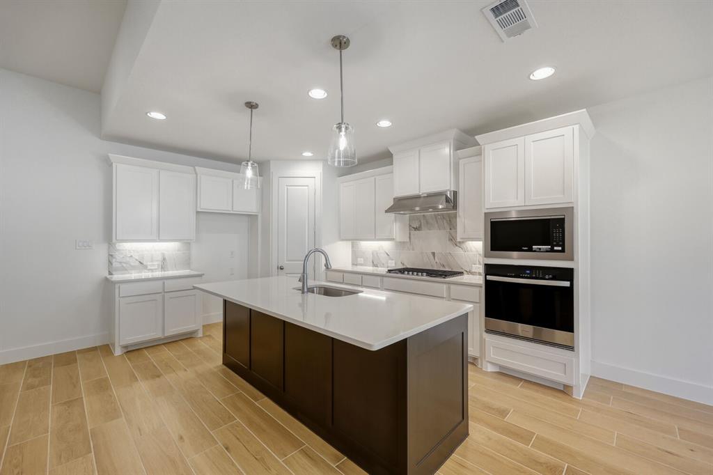 180 Buffalo Boulevard Rhome, TX 76078 - Photo 5 of 28 a kitchen with a sink stove and cabinets
