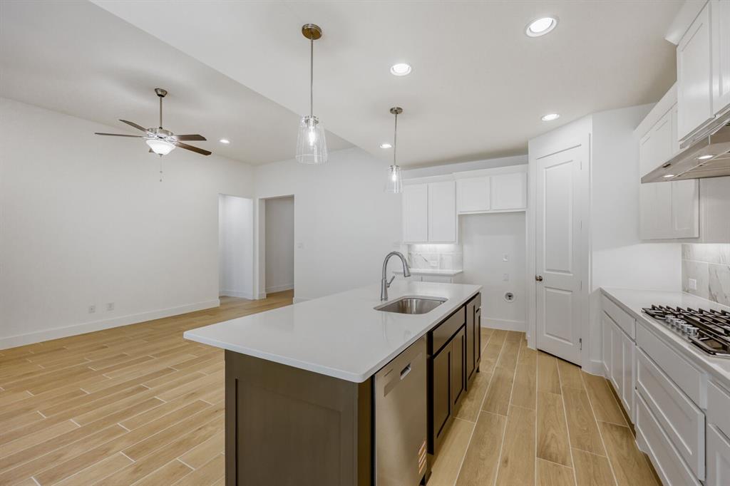 180 Buffalo Boulevard Rhome, TX 76078 - Photo 7 of 28 a kitchen with stainless steel appliances granite countertop a sink a stove and a refrigerator