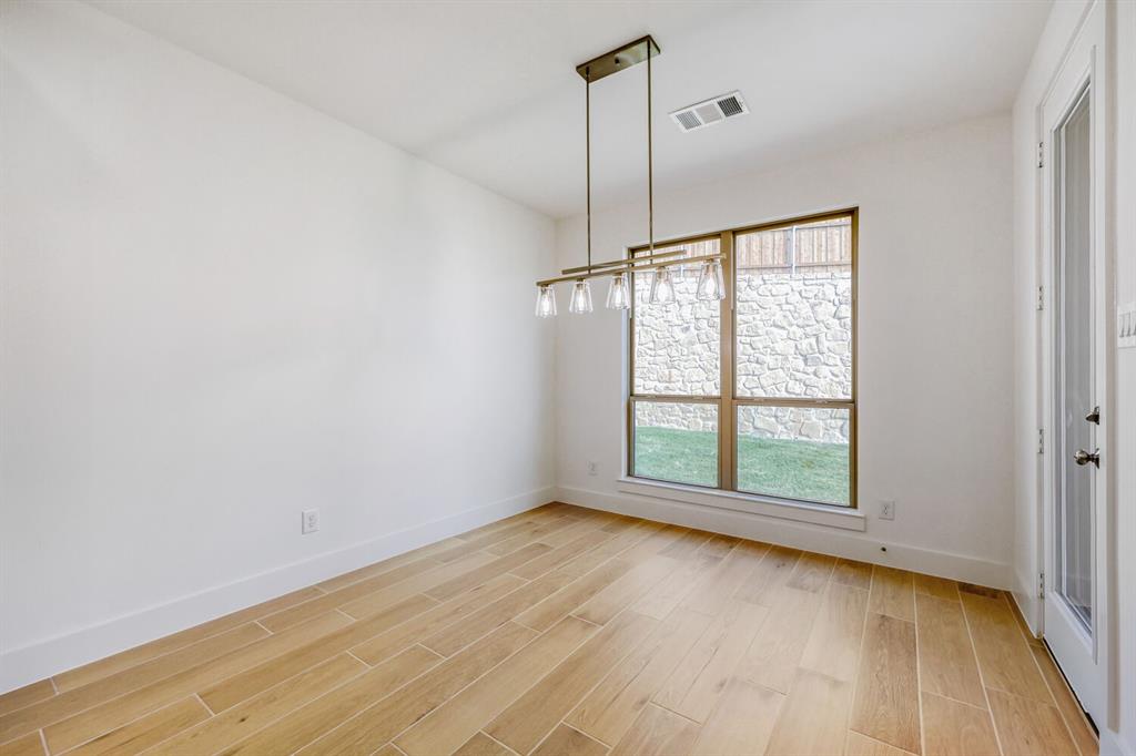 180 Buffalo Boulevard Rhome, TX 76078 - Photo 8 of 28 a view of an empty room with a window and hardwood floor