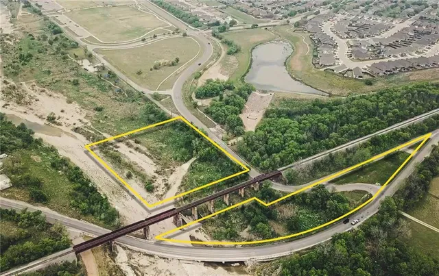 a view of swimming pool with a garden and plants