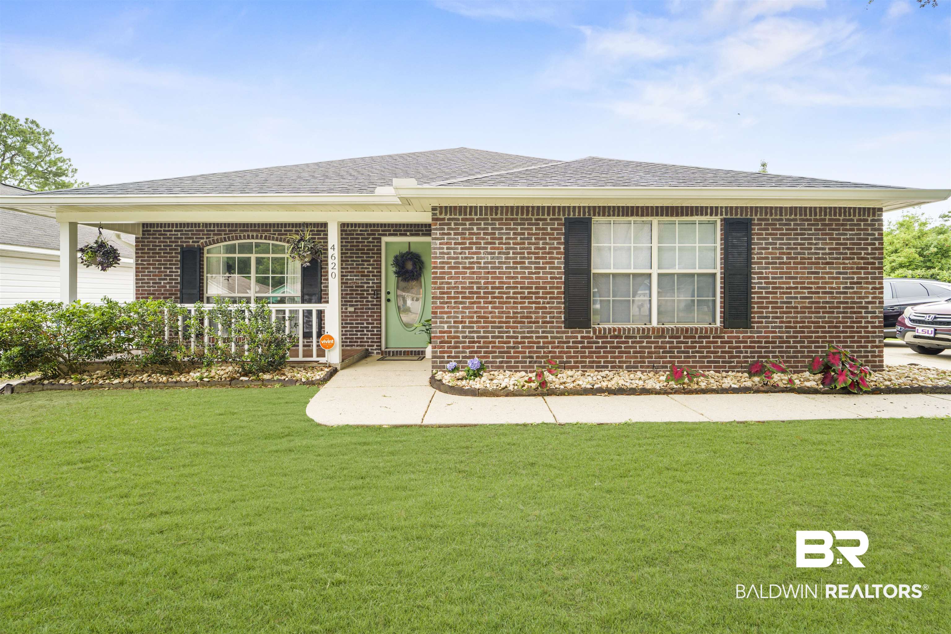 4620 Pine Boulevard Orange Beach, AL 36561 - Photo 1 of 49 Ranch-style home featuring a front yard, brick siding, a porch, and roof with shingles