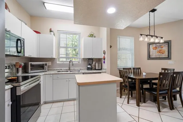 a kitchen with stainless steel appliances a refrigerator sink and microwave