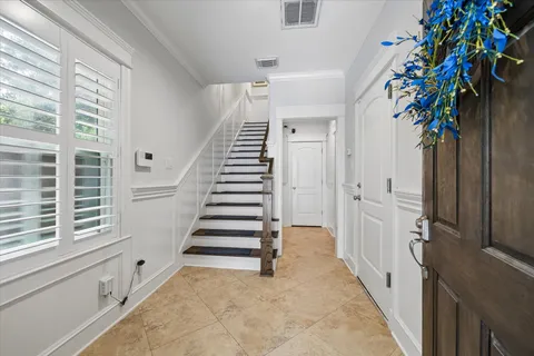 a view of entryway with paintings on the walls