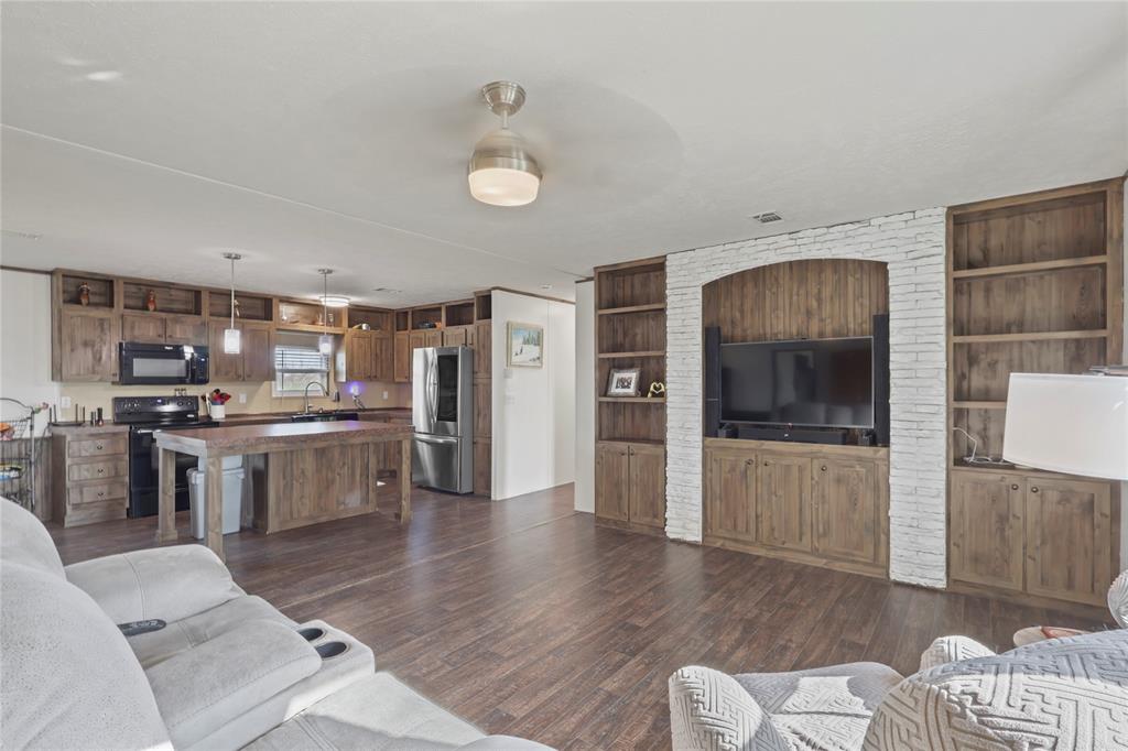 10240 Norrell Road Venus, TX 76084 - Photo 13 of 38 Living room with dark wood-style flooring and built in features