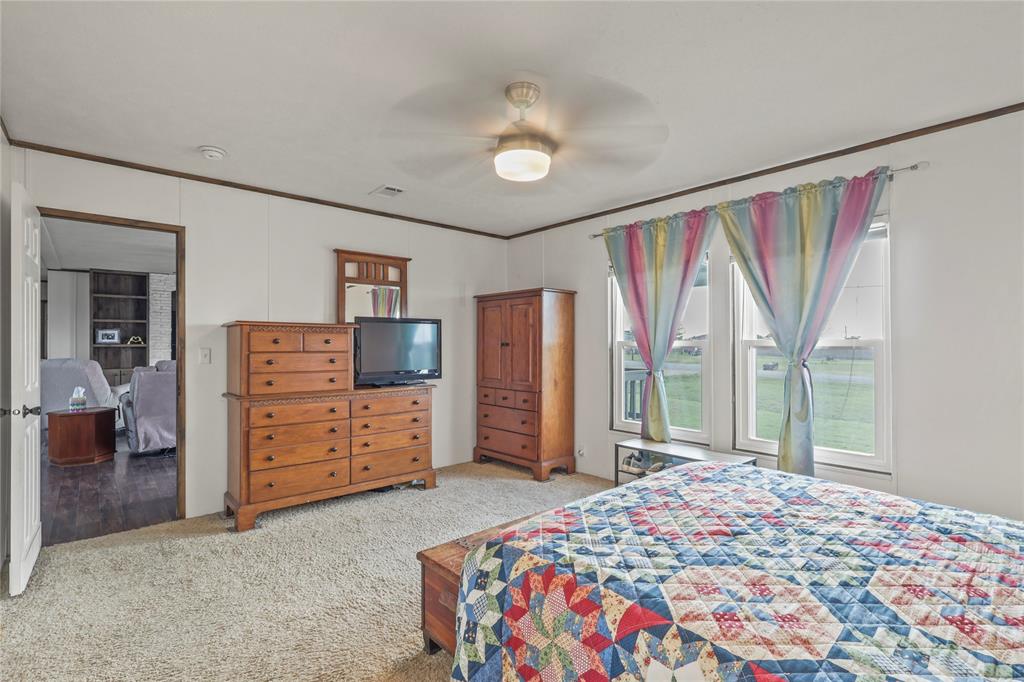 10240 Norrell Road Venus, TX 76084 - Photo 21 of 38 Carpeted bedroom with a ceiling fan and ornamental molding