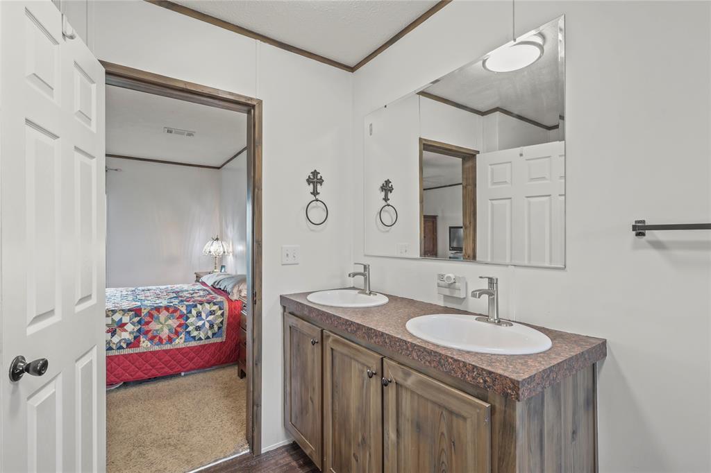 10240 Norrell Road Venus, TX 76084 - Photo 23 of 38 Ensuite bathroom featuring double vanity and crown molding