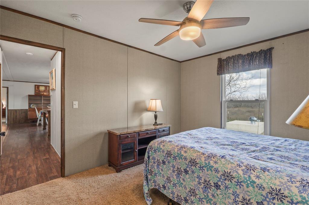 10240 Norrell Road Venus, TX 76084 - Photo 28 of 38 Carpeted bedroom featuring crown molding and ceiling fan