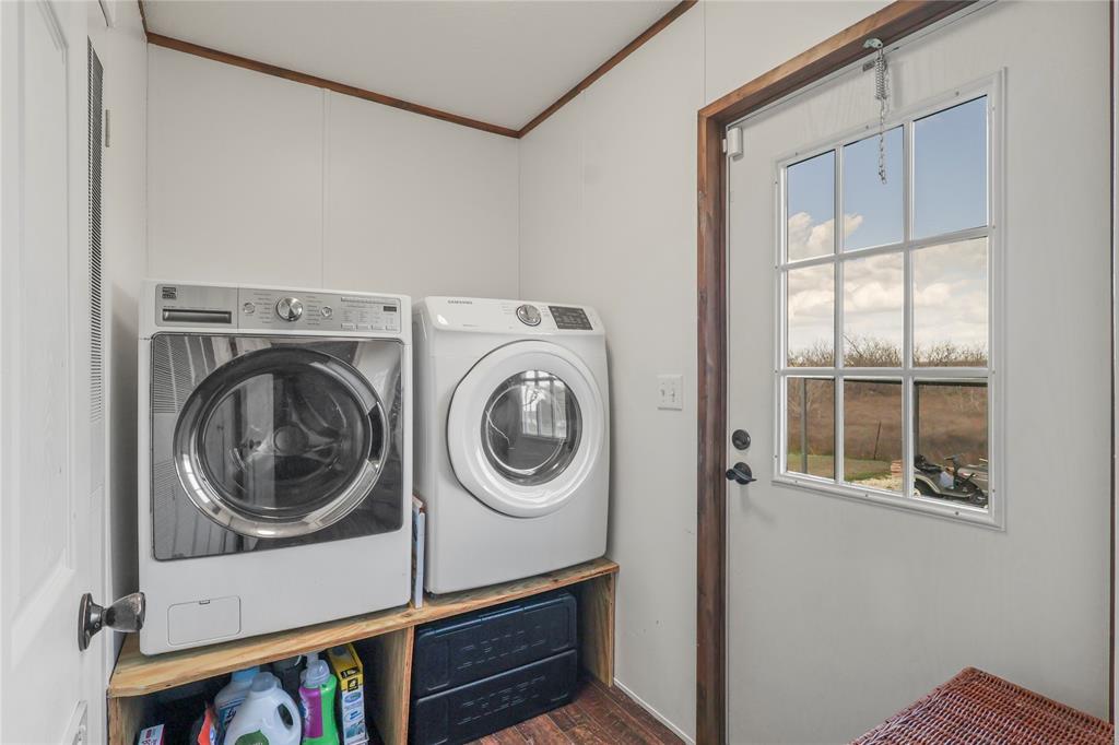 10240 Norrell Road Venus, TX 76084 - Photo 30 of 38 Laundry area with separate washer and dryer, ornamental molding, and dark wood-style flooring
