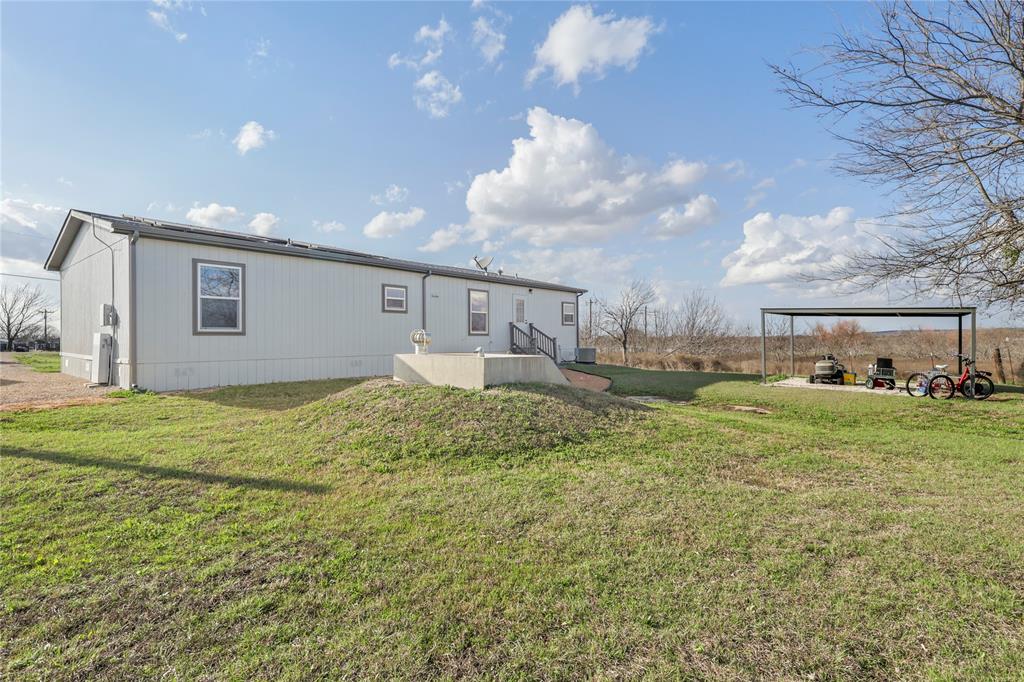 10240 Norrell Road Venus, TX 76084 - Photo 34 of 38 Back of house with a yard