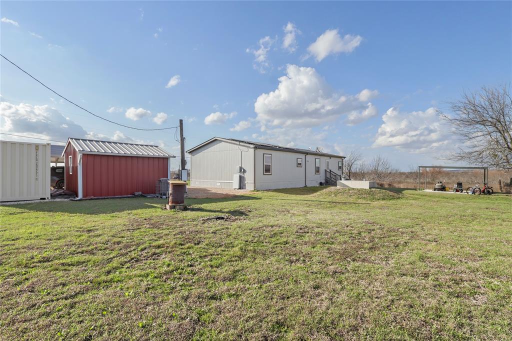 10240 Norrell Road Venus, TX 76084 - Photo 35 of 38 View of grassy yard with a storage shed