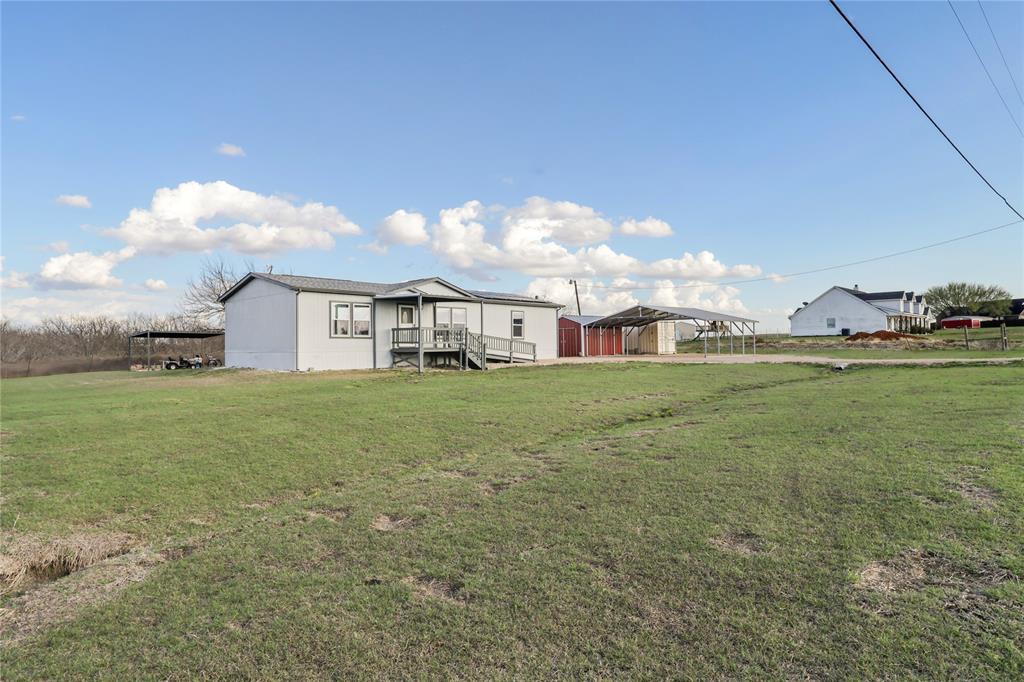 10240 Norrell Road Venus, TX 76084 - Photo 36 of 38 View of green lawn with a carport