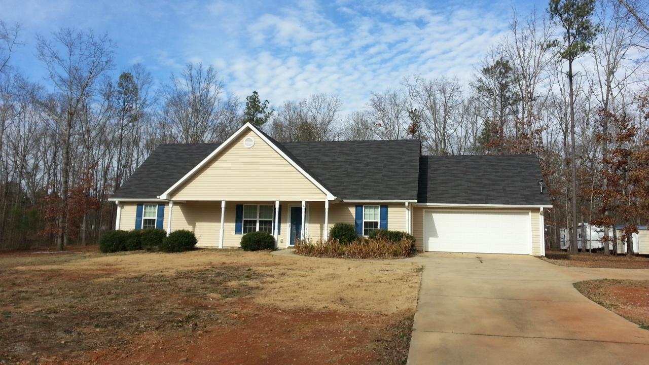 327 Evans Road Milner, GA 30257 - Photo 1 of 1 a view of a house with a yard and garage