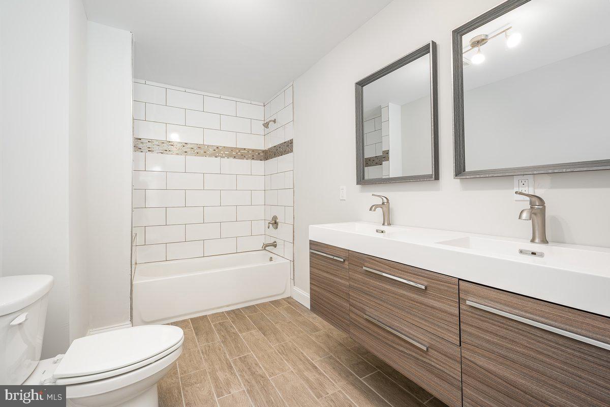 523 East 20th Street Baltimore, MD 21218 - Photo 12 of 28 a bathroom with a sink a toilet and shower