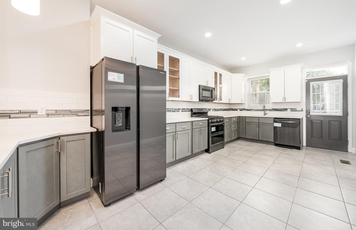 523 East 20th Street Baltimore, MD 21218 - Photo 2 of 28 a kitchen with stainless steel appliances granite countertop a refrigerator and a sink