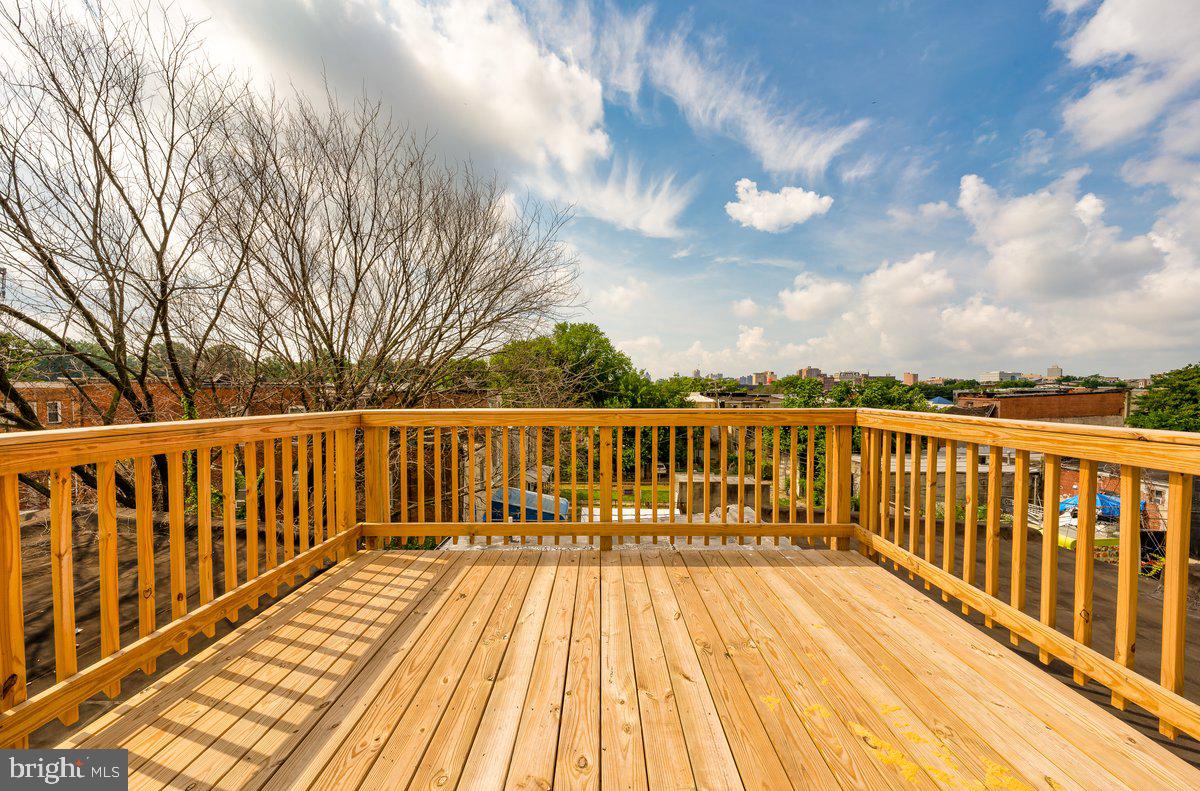 523 East 20th Street Baltimore, MD 21218 - Photo 5 of 28 a view of balcony with wooden floor and fence