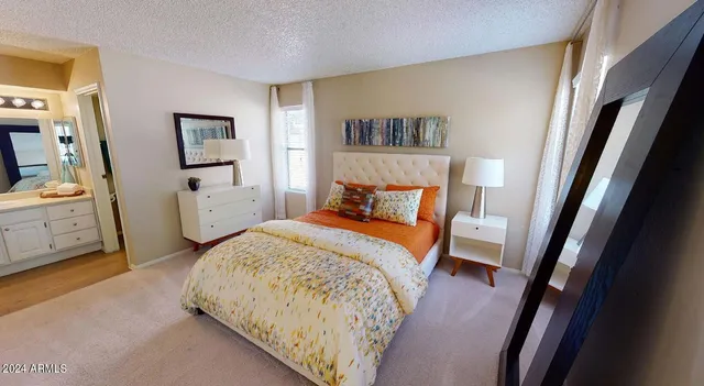 a bedroom with a bed and a view of bathroom