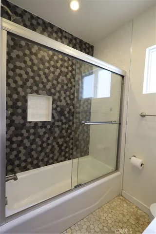 a bathroom with a shower and a bathtub