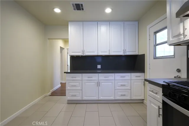 a kitchen with stainless steel appliances a stove a microwave a sink and cabinets