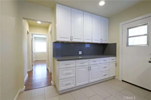a kitchen with white cabinets