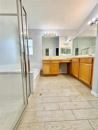a bathroom with a tub sink and mirror