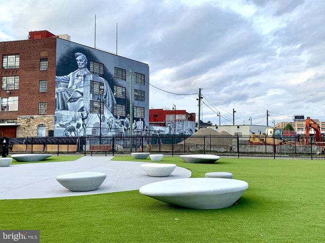 a front view of a building with sitting area