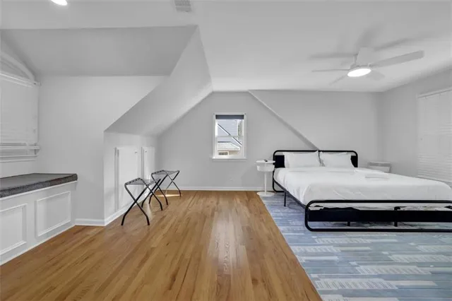 a bathroom with a granite countertop sink a toilet and a mirror
