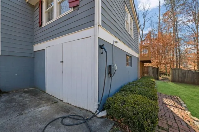 a kitchen with stainless steel appliances kitchen island granite countertop a stove a sink a refrigerator and white cabinets with wooden floor