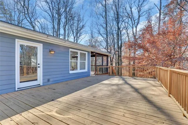 a view of balcony with wooden floor and outdoor seating