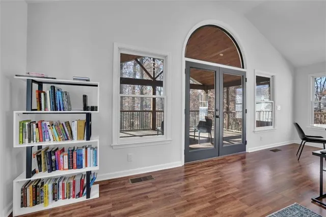 a view of room with workspace and wooden floor