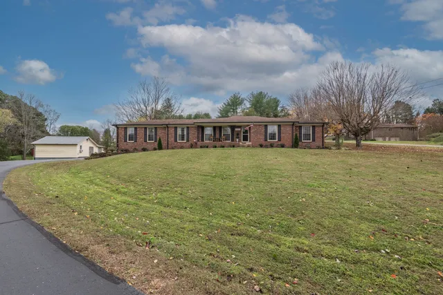 a view of a house with yard and deck