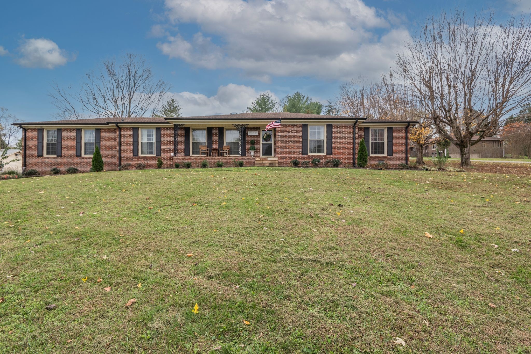 111 Proffitt Street Carthage, TN 37030 - Photo 2 of 38 a view of a yard in front of a brick house with large windows