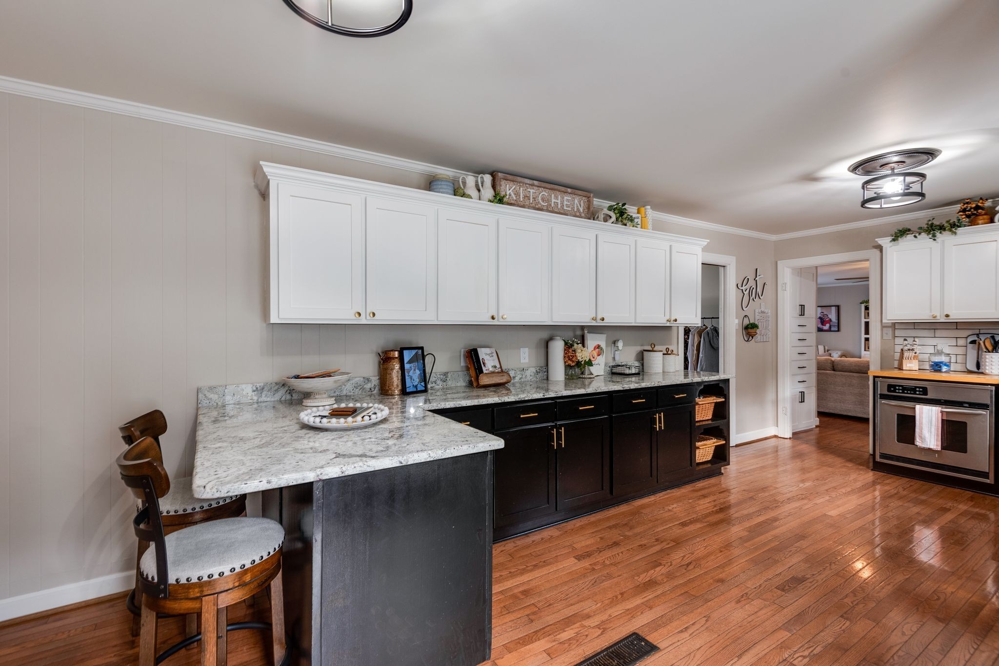 111 Proffitt Street Carthage, TN 37030 - Photo 21 of 38 a kitchen with kitchen island granite countertop a sink cabinets and wooden floor