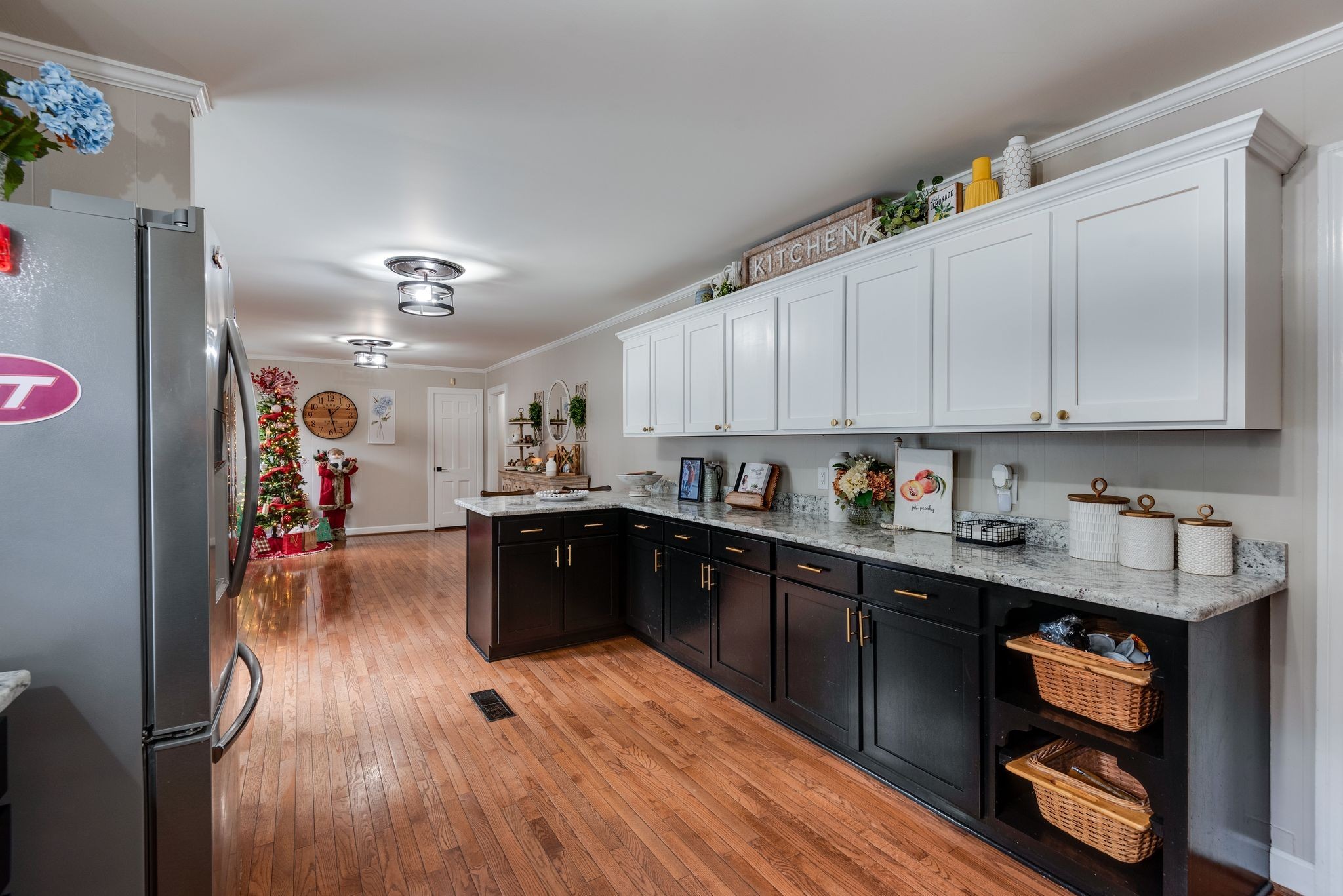 111 Proffitt Street Carthage, TN 37030 - Photo 24 of 38 a kitchen with stainless steel appliances granite countertop a refrigerator a sink dishwasher a stove and white countertops with wooden floor