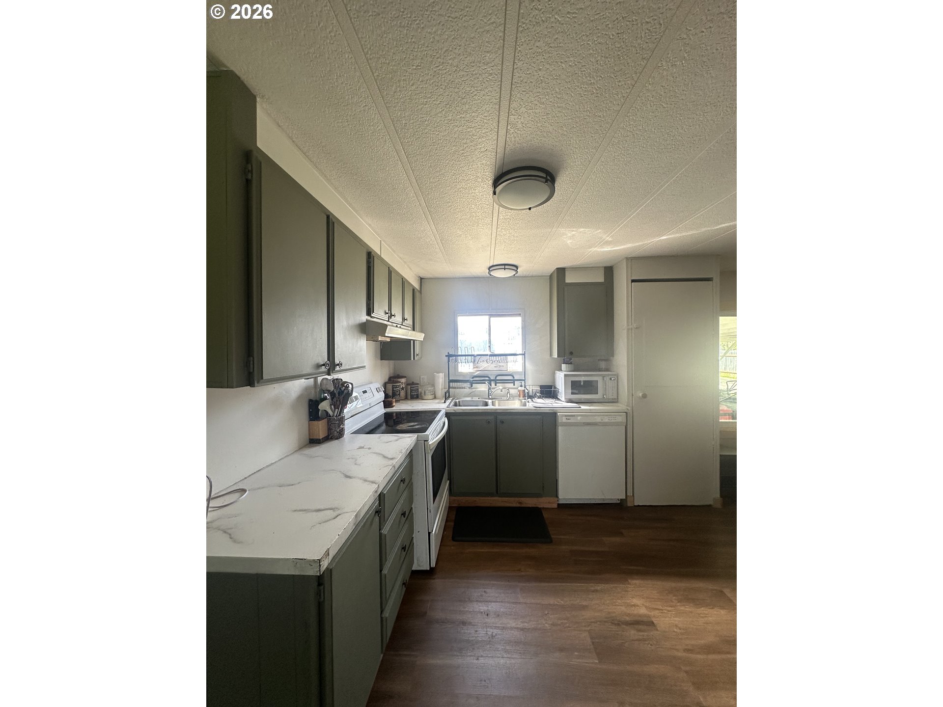 355 North 8th Street Lakeside, OR 97449 - Photo 13 of 22 a kitchen with a sink and cabinets