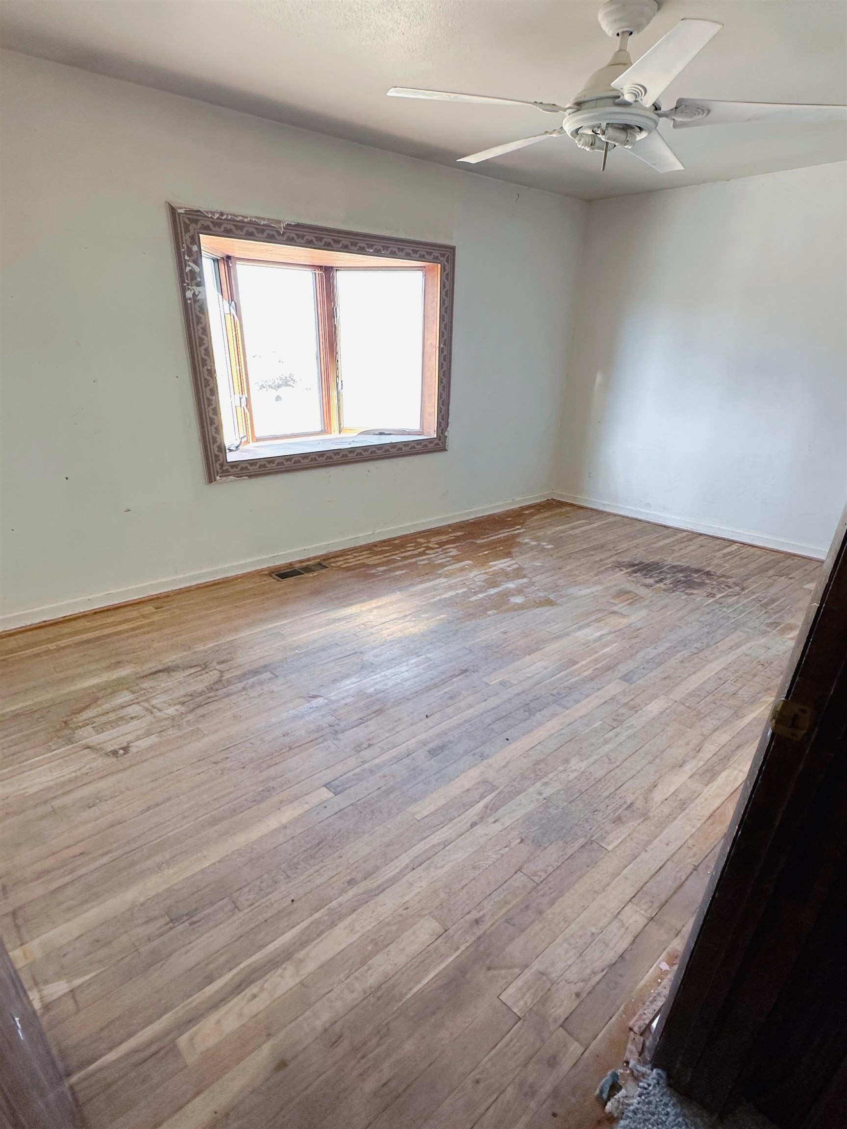 1818 County Road 46 Rangely, CO 81648 - Photo 12 of 23 an empty room with wooden floor windows and fan