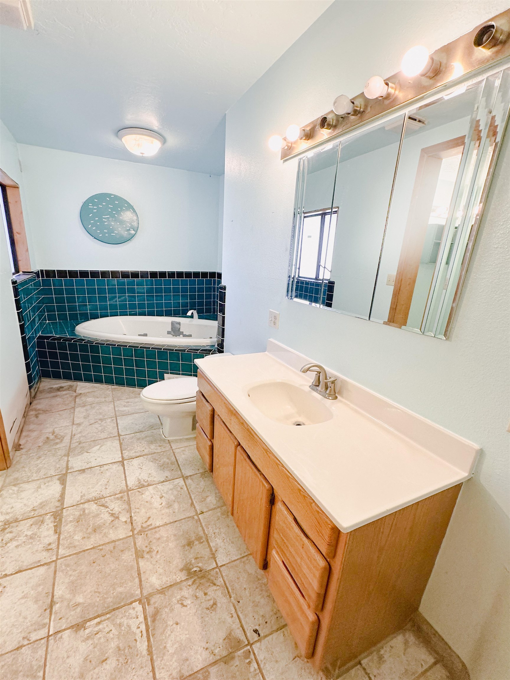 1818 County Road 46 Rangely, CO 81648 - Photo 15 of 23 a bathroom with a sink a mirror and a bathtub